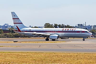 When did Qantas begin international passenger flights?