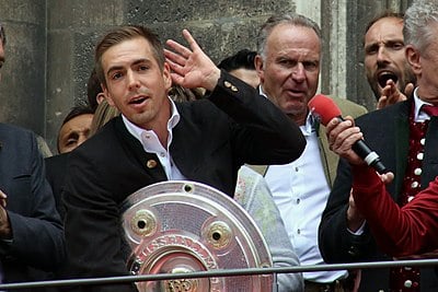 Which of these honors did Philipp Lahm achieve as part of the Treble with Bayern Munich?
